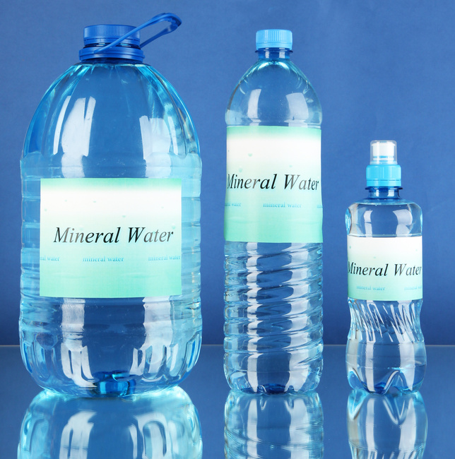 Different Water Bottles with Label on Blue Background